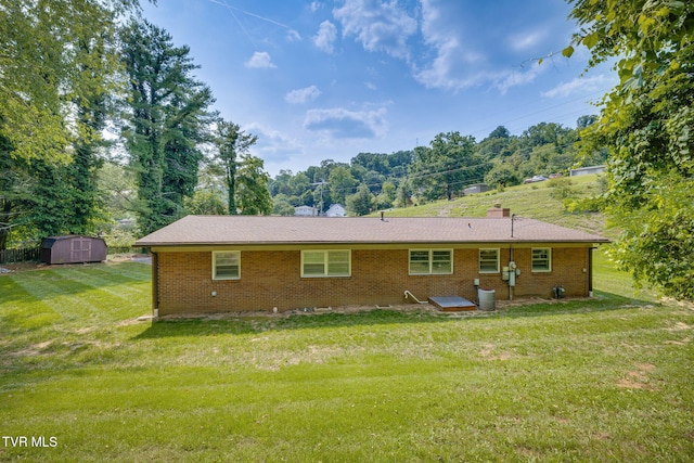 309 Knob Hill Dr, Bristol, TN 37620 - rear view of house featuring a shed, brick siding, and a yard