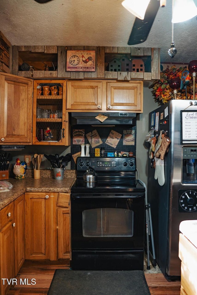 3504 James Phillips Way, Sevierville, TN 37876 - kitchen featuring black range with electric cooktop, stainless steel fridge with ice dispenser, light wood-style flooring, brown cabinetry, and a textured ceiling
