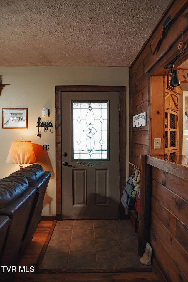 3504 James Phillips Way, Sevierville, TN 37876 - entrance foyer with wood walls, a textured ceiling, and tile patterned flooring