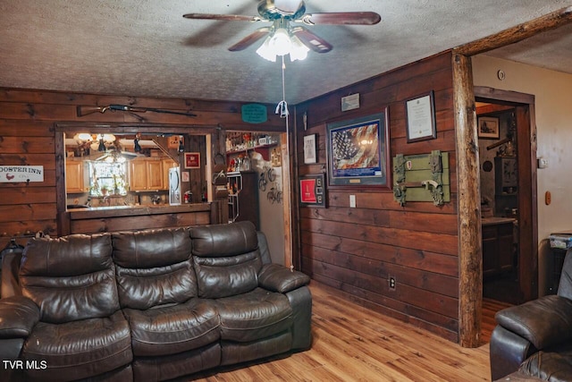 3504 James Phillips Way, Sevierville, TN 37876 - living area featuring wood walls, ceiling fan, a textured ceiling, and light wood-style flooring
