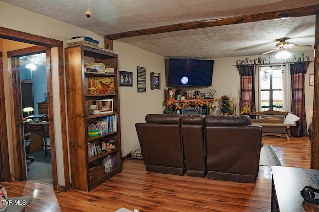3504 James Phillips Way, Sevierville, TN 37876 - living area with a ceiling fan, wood finished floors, a textured ceiling, and beam ceiling