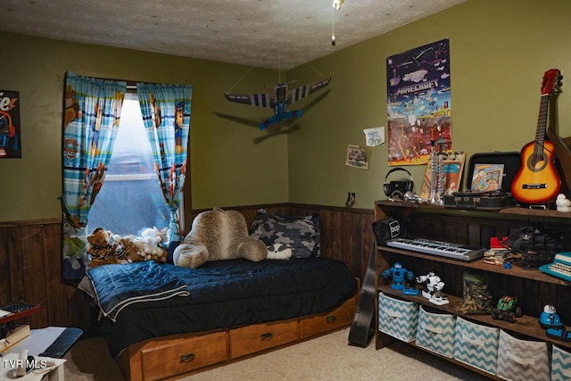 3504 James Phillips Way, Sevierville, TN 37876 - bedroom with a wainscoted wall, carpet, wood walls, and a textured ceiling