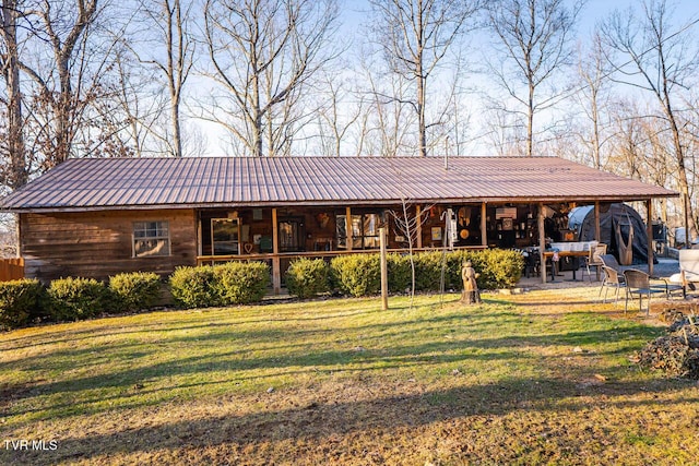 3504 James Phillips Way, Sevierville, TN 37876 - rear view of house featuring a lawn and a metal roof