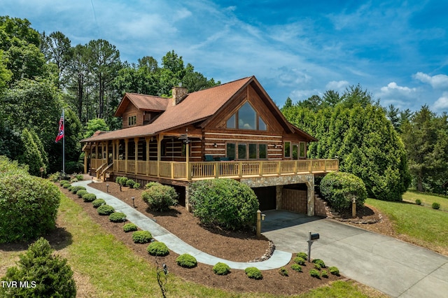 289 Harbor View Rd, Butler, TN 37640 - log home featuring concrete driveway, a chimney, an attached garage, stone siding, and a deck