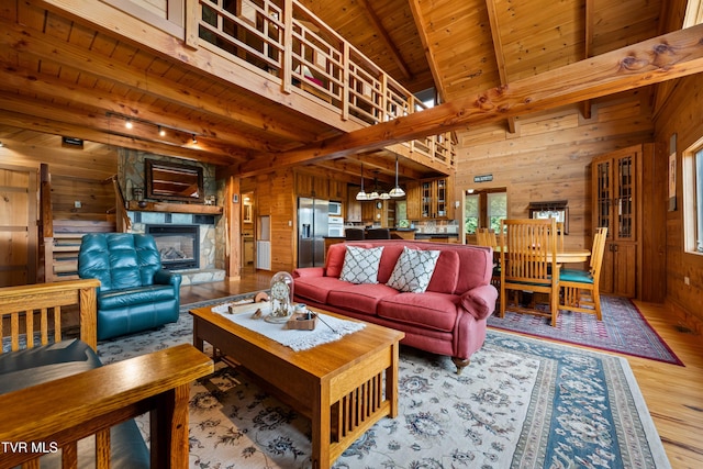 289 Harbor View Rd, Butler, TN 37640 - living area with wooden walls, a wooden ceiling with exposed beams, wood finished floors, a fireplace, and a chandelier