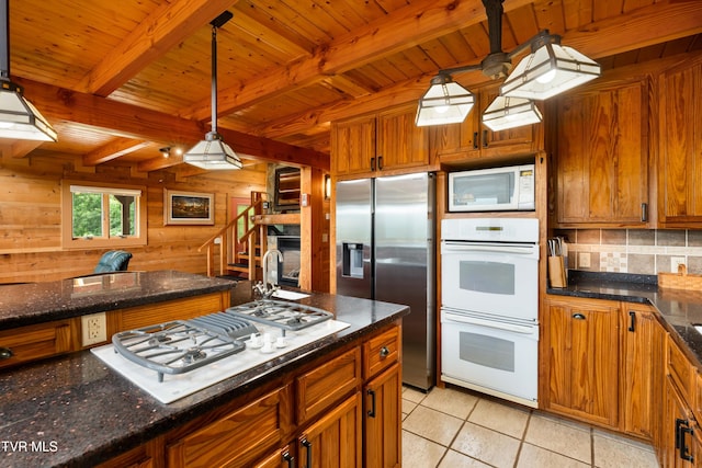 289 Harbor View Rd, Butler, TN 37640 - kitchen with white appliances, wooden walls, brown cabinetry, a wood ceiling with exposed beams, and tasteful backsplash