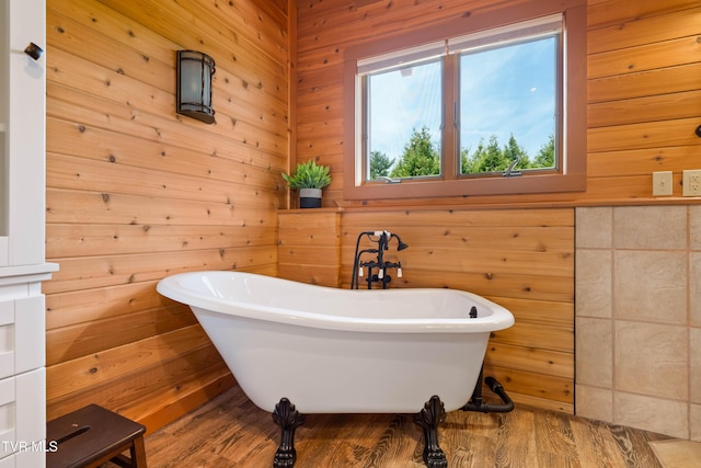 289 Harbor View Rd, Butler, TN 37640 - full bath featuring a freestanding tub, wooden walls, and wood finished floors