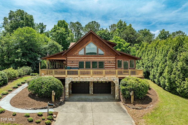 289 Harbor View Rd, Butler, TN 37640 - cabin with stone siding, driveway, and an attached garage