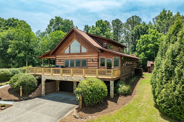 289 Harbor View Rd, Butler, TN 37640 - log home with concrete driveway, a garage, stone siding, and a deck