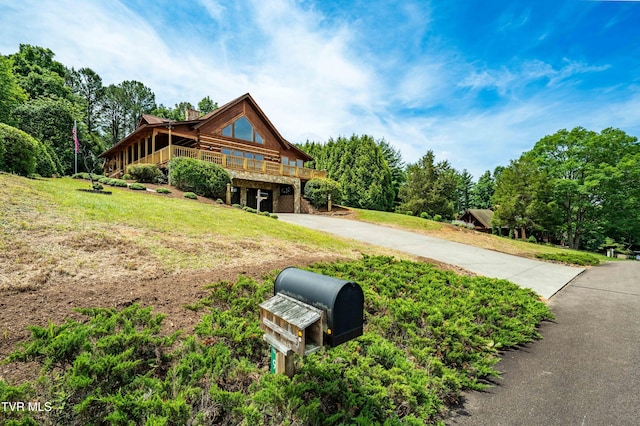 289 Harbor View Rd, Butler, TN 37640 - cabin with driveway, a chimney, a front yard, a garage, and a wooden deck