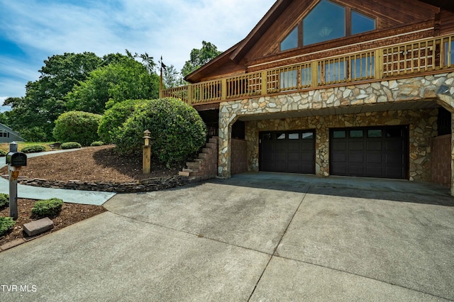 289 Harbor View Rd, Butler, TN 37640 - view of front of house with stone siding, an attached garage, and driveway