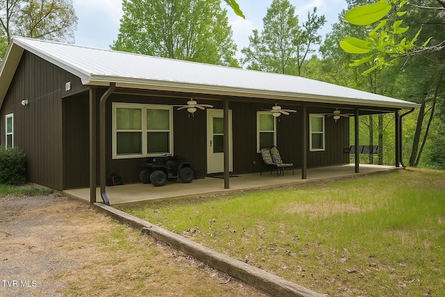 3516 James Phillips Way, Sevierville, TN 37876 - back of property featuring ceiling fan, a patio area, and a lawn