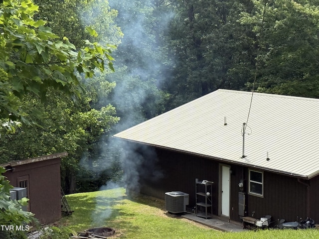 3516 James Phillips Way, Sevierville, TN 37876 - back of house with a yard, an outdoor fire pit, and a metal roof