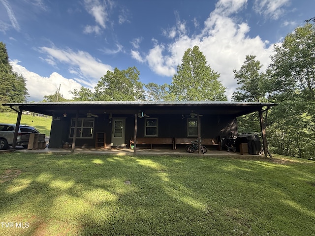 3516 James Phillips Way, Sevierville, TN 37876 - back of property featuring a lawn and a ceiling fan