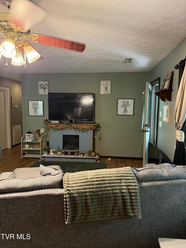 3516 James Phillips Way, Sevierville, TN 37876 - living area featuring a ceiling fan, wood finished floors, a textured ceiling, and a fireplace