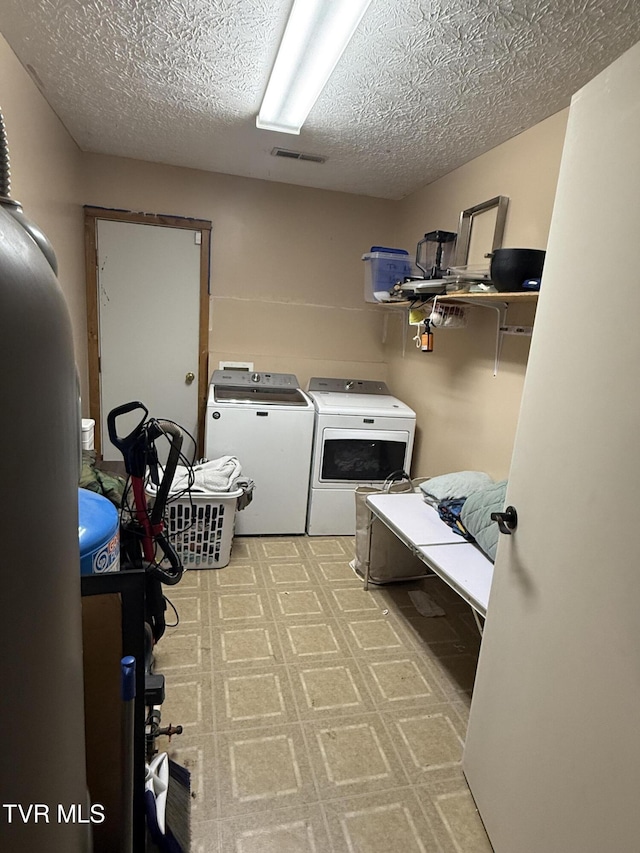 3516 James Phillips Way, Sevierville, TN 37876 - washroom with washing machine and dryer and a textured ceiling