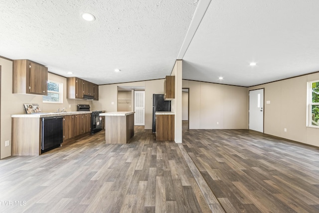 1826 Loop Rd, Lafollette, TN 37766 - kitchen featuring black appliances, open floor plan, dark wood-style flooring, light countertops, and a textured ceiling