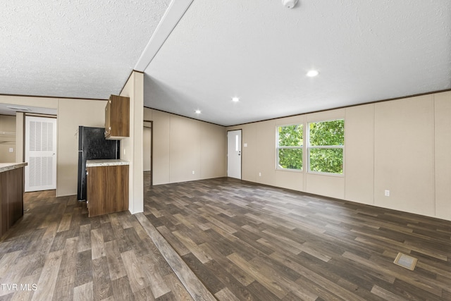 1826 Loop Rd, Lafollette, TN 37766 - unfurnished living room featuring dark wood-type flooring, a textured ceiling, and recessed lighting