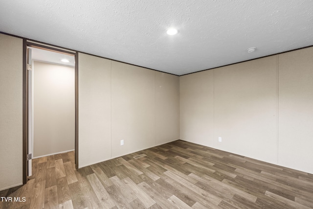 1826 Loop Rd, Lafollette, TN 37766 - unfurnished bedroom featuring wood finished floors, a textured ceiling, and recessed lighting