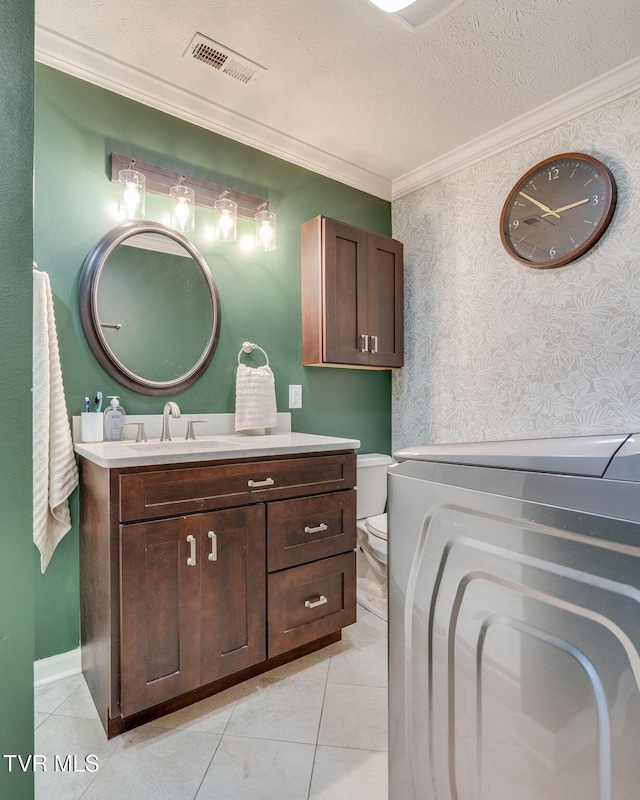 1933 Sand St, Kingsport, TN 37660 - bathroom with washer / clothes dryer, crown molding, vanity, tile patterned flooring, and a textured ceiling