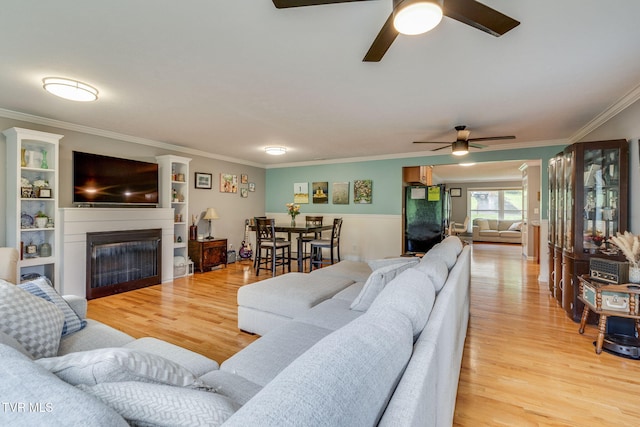 1933 Sand St, Kingsport, TN 37660 - living area featuring a ceiling fan, crown molding, a fireplace, and light wood-style floors