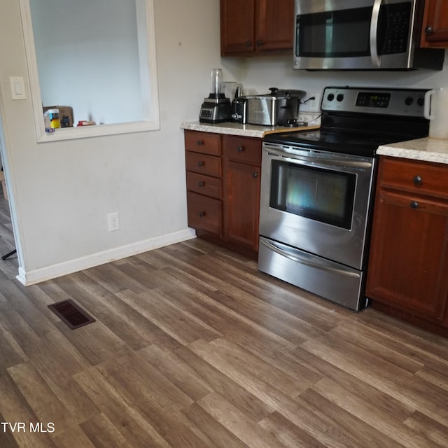 206 Hialeah Dr, Kingsport, TN 37660 - kitchen with stainless steel appliances, dark wood-style flooring, and light stone countertops