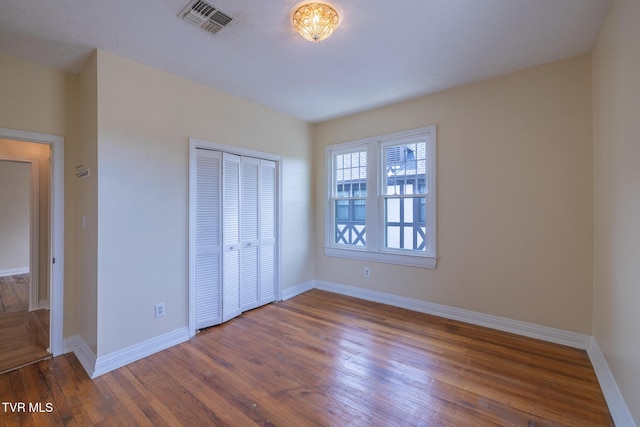 701 W Locust St Unit 34, Johnson City, TN 37604 - unfurnished bedroom with wood finished floors and a closet