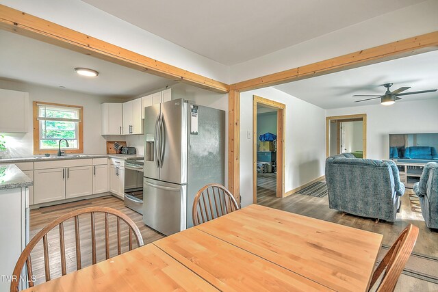 524 Boring Chapel Rd, Gray, TN 37615 - kitchen with stainless steel appliances, light wood-type flooring, light countertops, white cabinetry, and ceiling fan