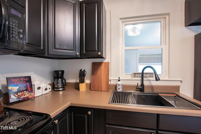2637 Bay St, Bristol, TN 37620 - kitchen with black electric range, light countertops, and dark cabinets