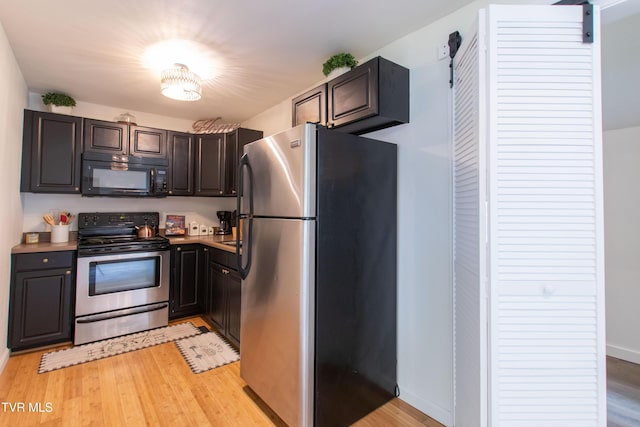 2637 Bay St, Bristol, TN 37620 - kitchen featuring stainless steel appliances, light wood-style flooring, dark brown cabinets, and light countertops