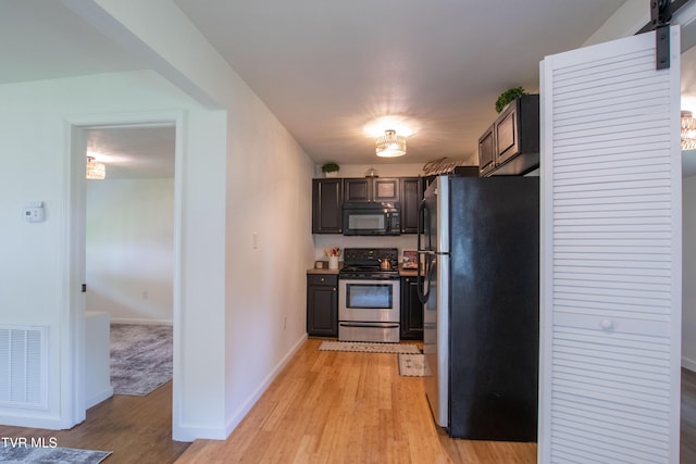 2637 Bay St, Bristol, TN 37620 - kitchen featuring stainless steel appliances, light wood-style flooring, and dark brown cabinetry