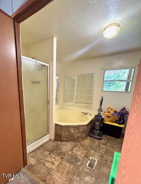 222 SW Azalea Dr, Wise, VA 24293 - bathroom featuring a shower stall, a garden tub, and a textured ceiling