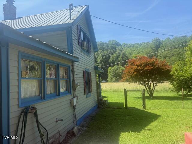 123 Mcmahan Gibbs Rd, Roan Mountain, TN 37687 - view of side of home featuring a chimney, a standing seam roof, and a metal roof