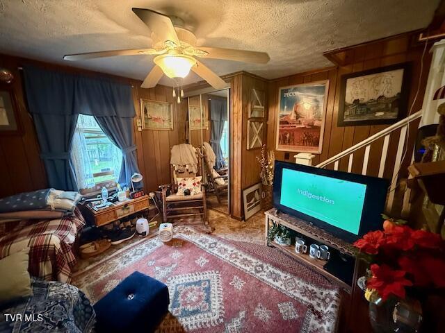 123 Mcmahan Gibbs Rd, Roan Mountain, TN 37687 - sitting room with a textured ceiling, ceiling fan, and wood walls