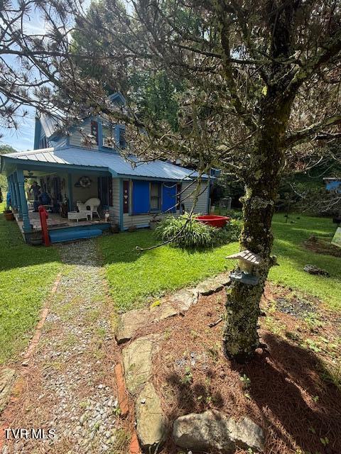 123 Mcmahan Gibbs Rd, Roan Mountain, TN 37687 - view of green lawn featuring a porch