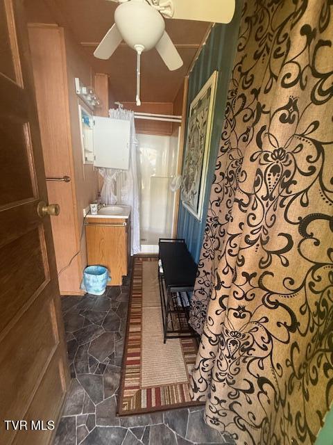 123 Mcmahan Gibbs Rd, Roan Mountain, TN 37687 - full bath with vanity, ceiling fan, stone finish floors, and a shower with curtain