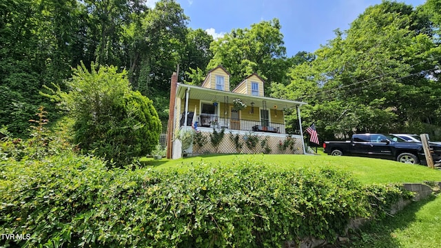 3135 3rd Ave, Saint Paul, VA 24283 - view of front facade with covered porch, a front yard, and a chimney