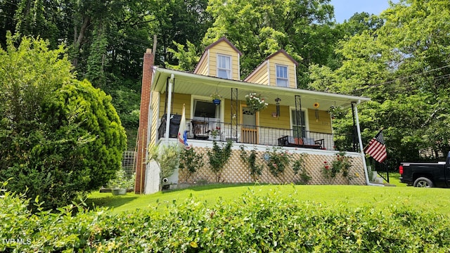 3135 3rd Ave, Saint Paul, VA 24283 - view of front facade featuring covered porch, a front yard, and a chimney