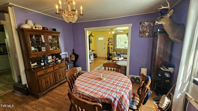 3135 3rd Ave, Saint Paul, VA 24283 - dining area featuring wood finished floors, a chandelier, a ceiling fan, and crown molding