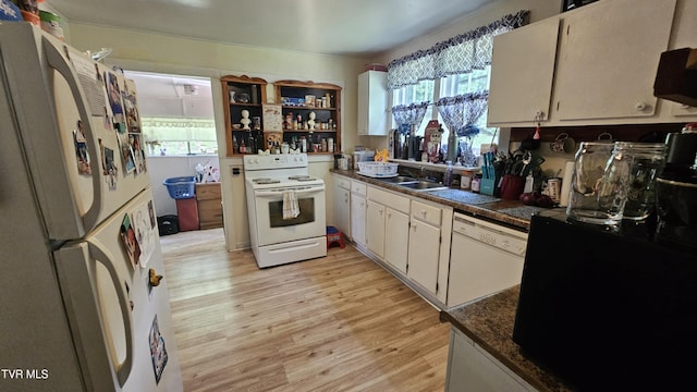3135 3rd Ave, Saint Paul, VA 24283 - kitchen featuring white appliances, plenty of natural light, light wood-type flooring, and dark countertops