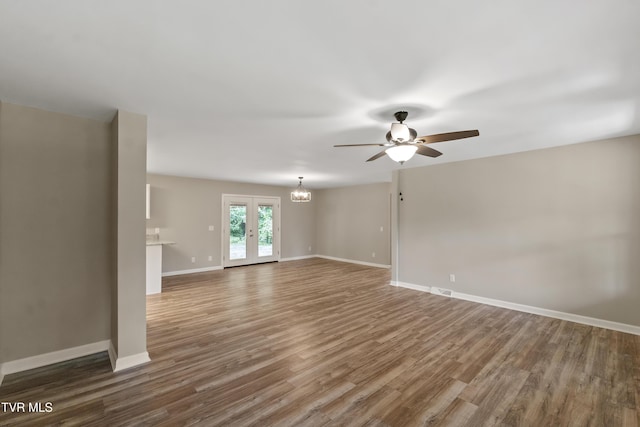 113 Paul Mathes Rd, Chuckey, TN 37641 - unfurnished room featuring a ceiling fan, a chandelier, and wood finished floors