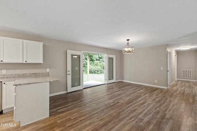 113 Paul Mathes Rd, Chuckey, TN 37641 - unfurnished living room with a chandelier and wood finished floors