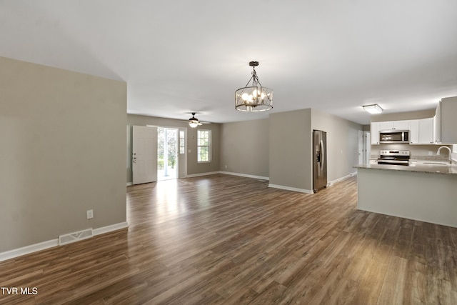 113 Paul Mathes Rd, Chuckey, TN 37641 - unfurnished living room with a chandelier, dark wood finished floors, and ceiling fan