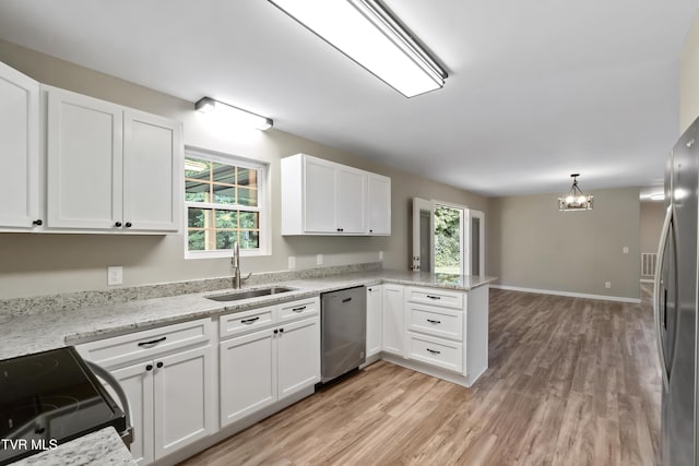 113 Paul Mathes Rd, Chuckey, TN 37641 - kitchen featuring appliances with stainless steel finishes, a chandelier, white cabinets, a peninsula, and light wood-type flooring