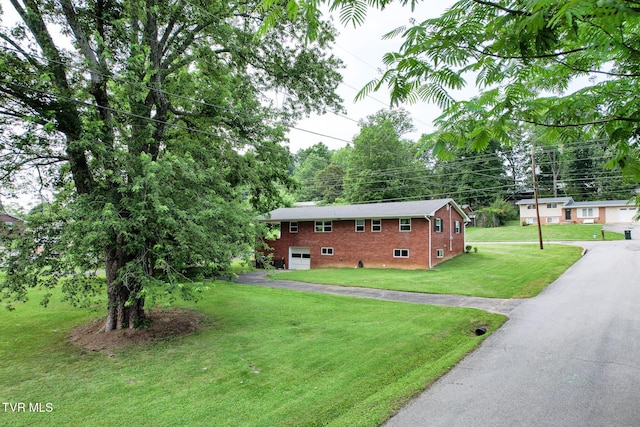 1908 Old Tusculum Rd, Greeneville, TN 37745 - view of front of house with asphalt driveway, a front lawn, a garage, and brick siding
