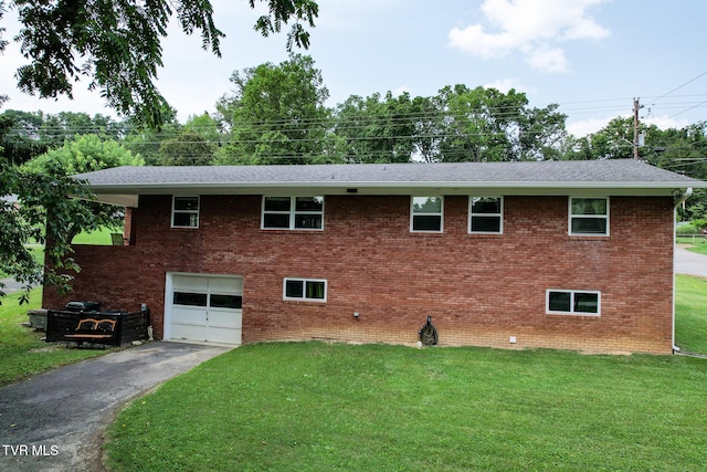 1908 Old Tusculum Rd, Greeneville, TN 37745 - view of front of home with asphalt driveway, an attached garage, a front yard, and brick siding