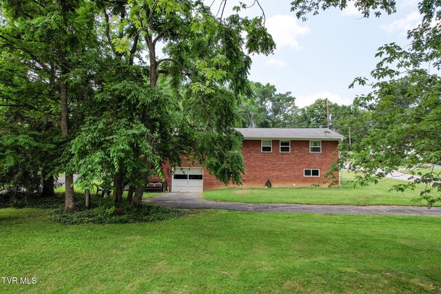 1908 Old Tusculum Rd, Greeneville, TN 37745 - view of front of property featuring asphalt driveway, brick siding, a front lawn, and a garage