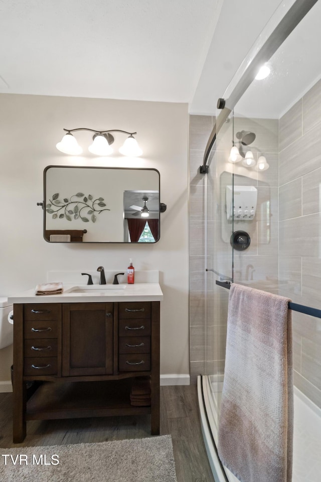 1908 Old Tusculum Rd, Greeneville, TN 37745 - bathroom featuring vanity, wood finished floors, a shower stall, and ceiling fan