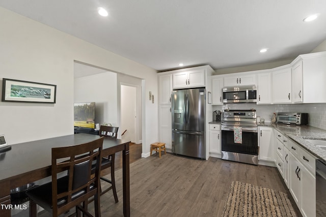 1908 Old Tusculum Rd, Greeneville, TN 37745 - kitchen with appliances with stainless steel finishes, white cabinets, light stone countertops, tasteful backsplash, and recessed lighting