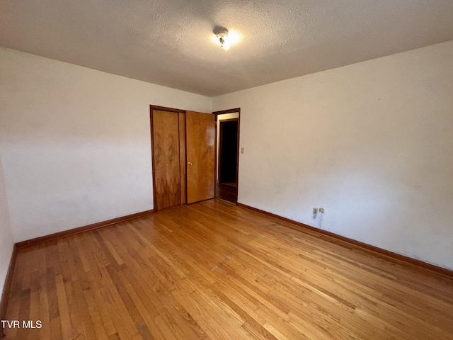 6361 Dr Thomas Walker Rd, Rose Hill, VA 24281 - unfurnished bedroom featuring light wood-style flooring, a closet, and a textured ceiling